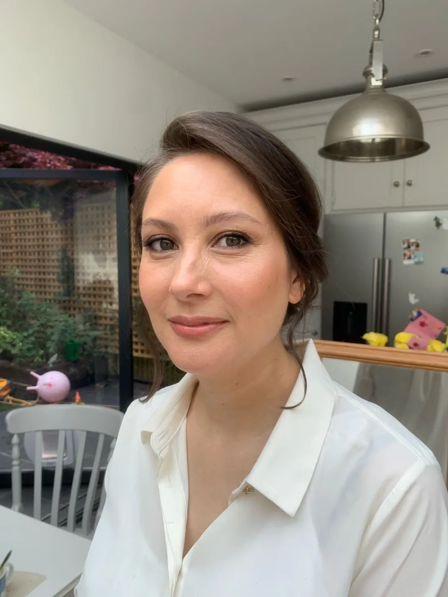 Close-up of finished soft bridal makeup, neutral eye, defined brows, glowing skin